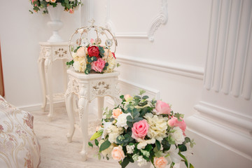 Artificial flowers. Vase with a flower arrangement in an expensive interior.