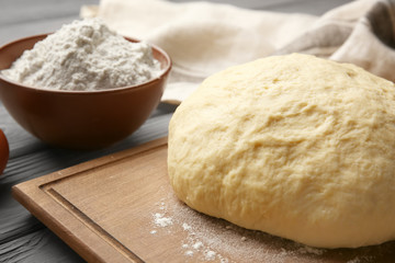Raw dough on wooden board