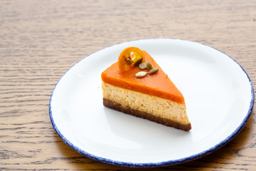 Pie with an orange top and the bottom coffee lies on the plate