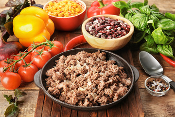 Cooked minced meat and vegetables on kitchen table