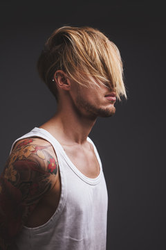 Young man with blond hair covering his face