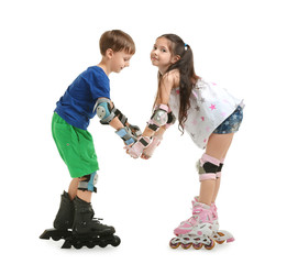 Cute children on roller skates against white background