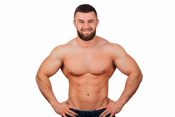 Portrait of a strong bearded male fitness model, torso. White background, isolate. hands on his hips.