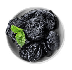 Bowl with tasty dried plums on white background