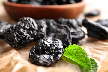 Tasty dried plums on table, closeup