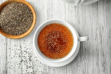Cup of tea with chia seeds on table