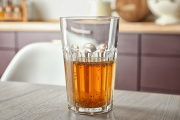 Glass of tea with chia seeds on table