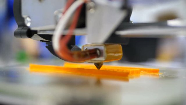 Printing with Plastic Wire Filament on 3D Printer. Automatic three dimensional 3d printer performs product creation. Modern 3D printing or additive manufacturing and robotic automation technology