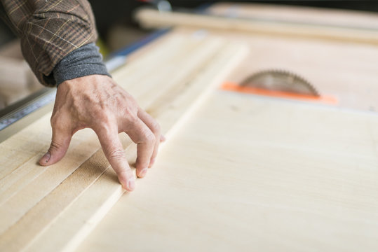 Man Cutting Wood on Table Saw