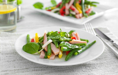 Plate with delicious green beans salad on table