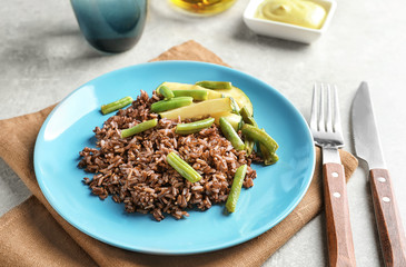 Red rice with vegetables on plate