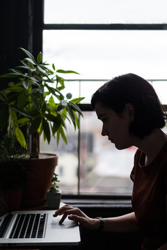 Brunette working with a Laptop from Home
