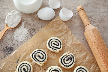 Raw rolls with poppy seeds on table