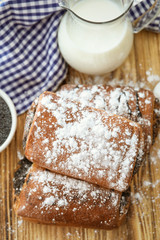 Tasty pastry with poppy seeds on table