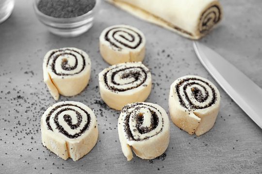 Raw rolls with poppy seeds on table