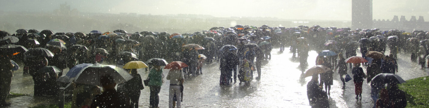 Rain,crowd,umbrellas and sun