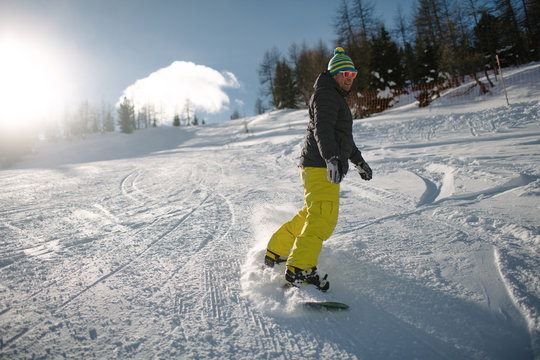 Young man snowboarding