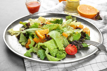 Metal dish with kale salad on table, closeup