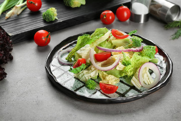 Dish with kale salad on table
