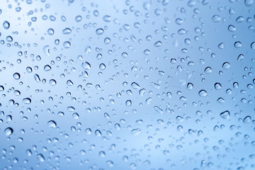 Rain drops on a window glass in a rainy day