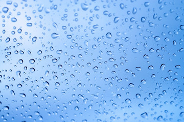 Rain drops on a window glass in a rainy day