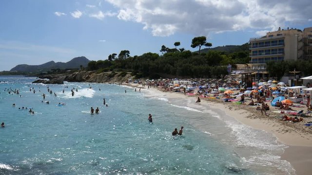 Holiday makers swimming on the Son Moll beach in Cala Ratjada Mallorca Spain