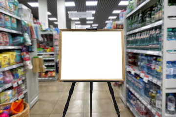 Supermarket, shelves with goods. Defocused image. Place in a wooden frame for your text or advertisement.