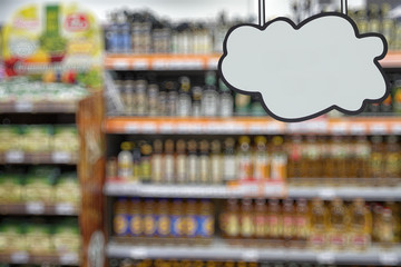Grocery supermarket. Shelves with food. Defocused image. Place for your text or advertisement.