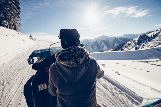 man driving snowmobile in snowcoverd landscape