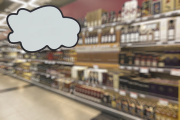 Alcohol department in the supermarket. Defocused image. Place for your text.