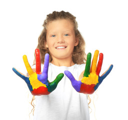 Little cute girl showing painted hands on white background