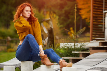 Autumn woman in house garden. Warm sunny weather. Fall concept