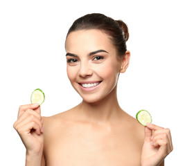 Young woman with cucumber slices on white background