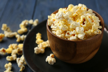 Bowl with popcorn on plate