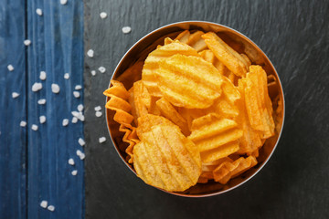 Bowl with potato chips on table