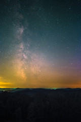 Fototapeta premium The center of the Milky Way as seen from the Schänzel Tower on the summit of the mountain Steigerkopf in the Palatinate Forest near Edenkoben in Germany.
