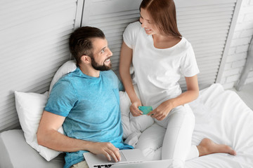 Obraz premium Young couple with laptop at home. Internet shopping concept
