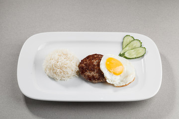 Meatball with fried egg, rice and cucumber