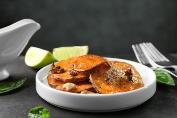 Plate with cooked sweet potato on table