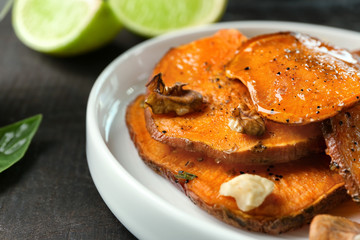 Plate with cooked sweet potato on table