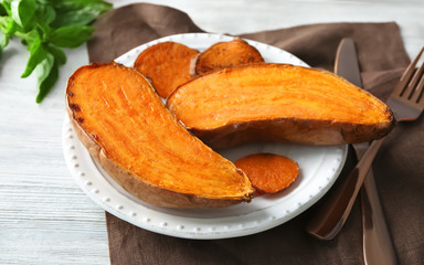 Plate with cooked sweet potato on table