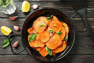 Dish with cooked sweet potato on table