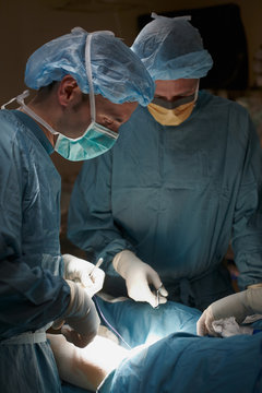 Close up of two surgeons at work in the operating room