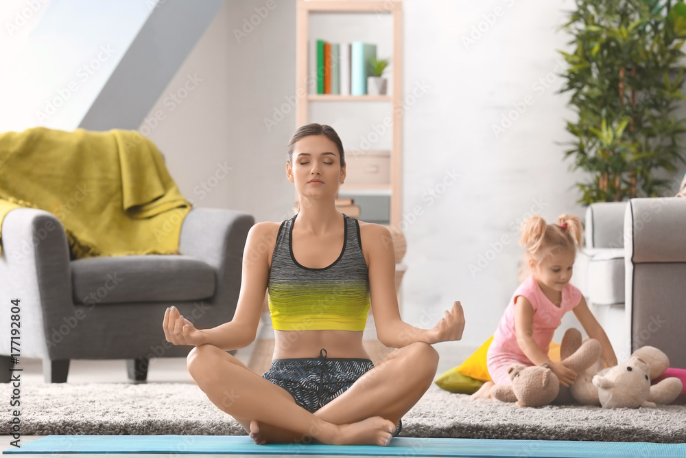 Canvas Prints Beautiful young woman practicing yoga at home