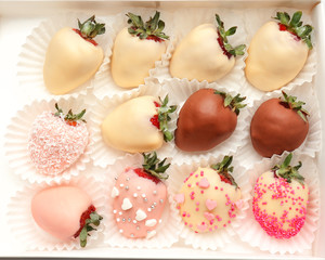 Box with tasty chocolate dipped and glazed strawberries, closeup