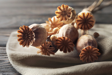 Bunch of poppy heads on table, closeup