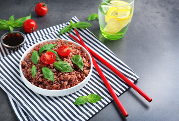 Plate with brown rice on table