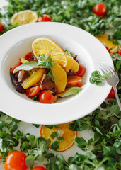 salad in oranges, tomatoes and bacon