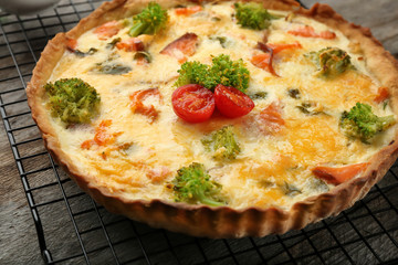 Tasty salmon quiche on cooling rack