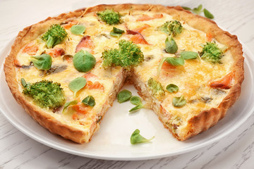 Tasty salmon quiche on plate